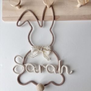 Personalized bunny name sign with lace bow in beige nursery decor