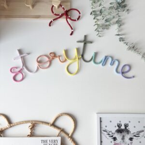 Pastel storytime wall sign creating a cozy kids reading corner designed to encourage children to enjoy books and quiet story tim