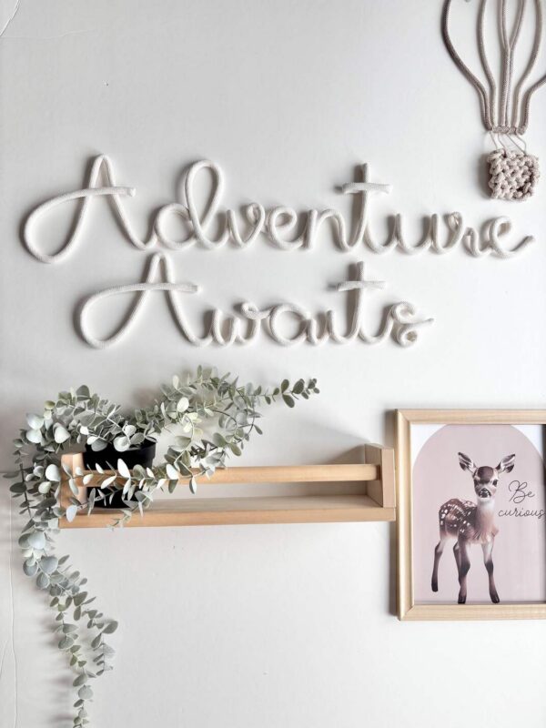 Adventure Awaits wall sign in kids bedroom above bed decor