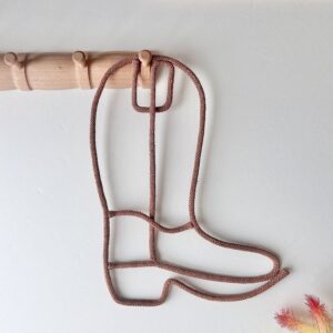 cowboy boot wall decor in western kids room hung on a peg