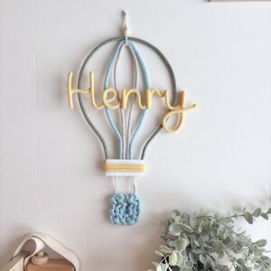 Personalized hot air balloon name sign in nursery wall decor above crib