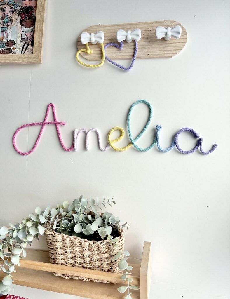 Personalized pastel name sign for first birthday gift in nursery room