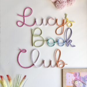 Pastel kids book club sign decorating soft Montessori style reading corner
