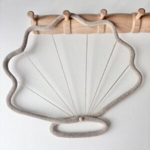 Coastal cowboy seashell wall decor styled in boys nursery with neutral tones