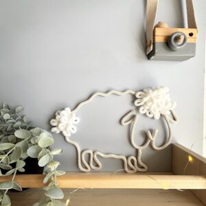 cute she displayed on a shelf against a wall in baby room / nursery