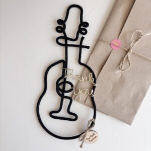Black guitar wall decor with “thank you” wire lettering and The Best Teacher wooden tag