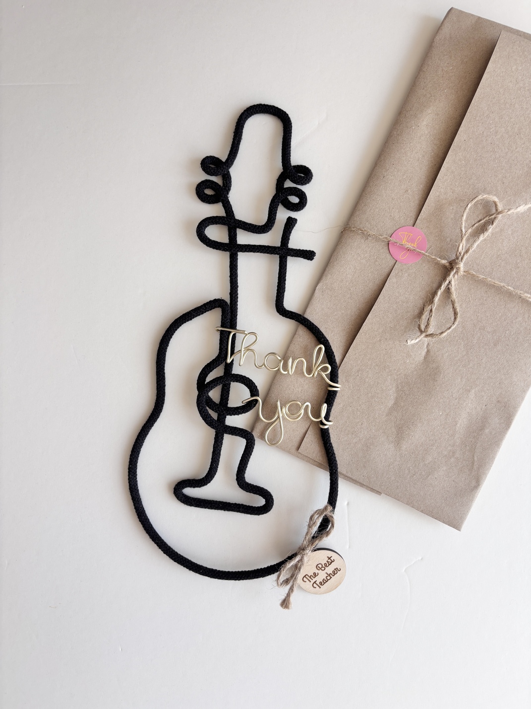 Black guitar wall decor with “thank you” wire lettering and The Best Teacher wooden tag
