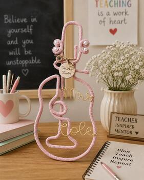 Handmade guitar-shaped teacher gift with wire name detail and engraved wooden tag on desk