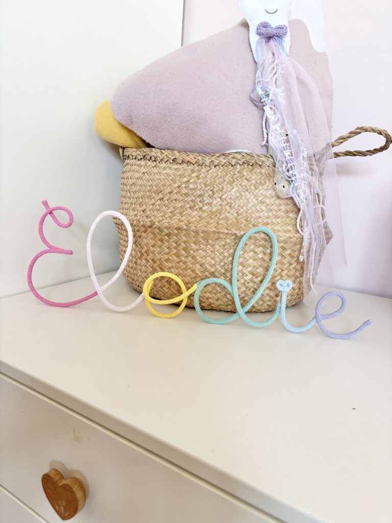 name Elodie in baby girl nursery rested on a shelf