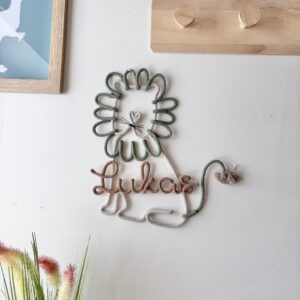 Custom lion name sign for a jungle-themed nursery, handcrafted wall decor for babies and children.