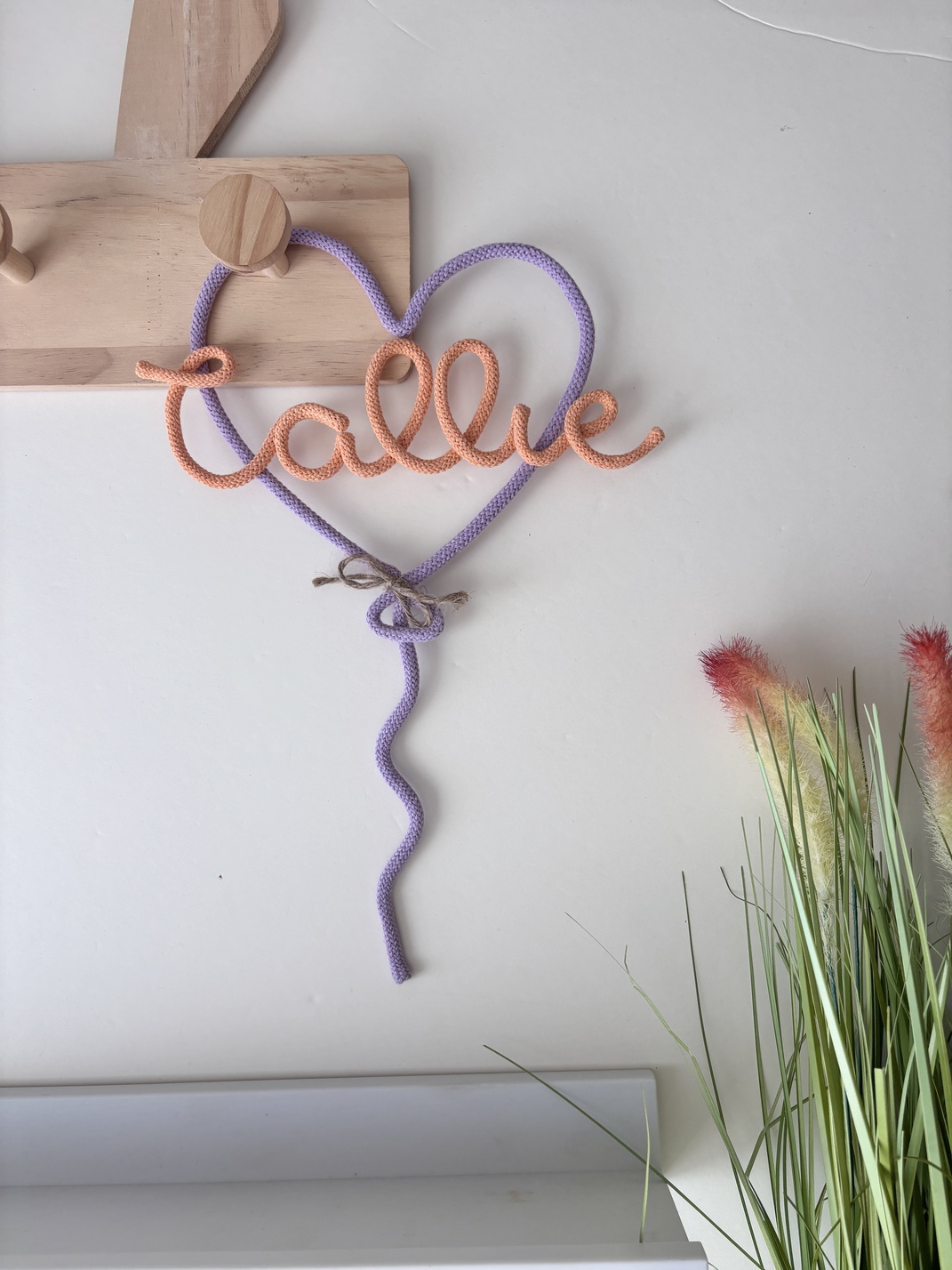 Custom name wall decor with heart balloon design for a cosy nursery.