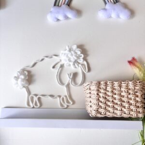 Handmade sheep nursery decor for a neutral baby room with soft cotton rope details.