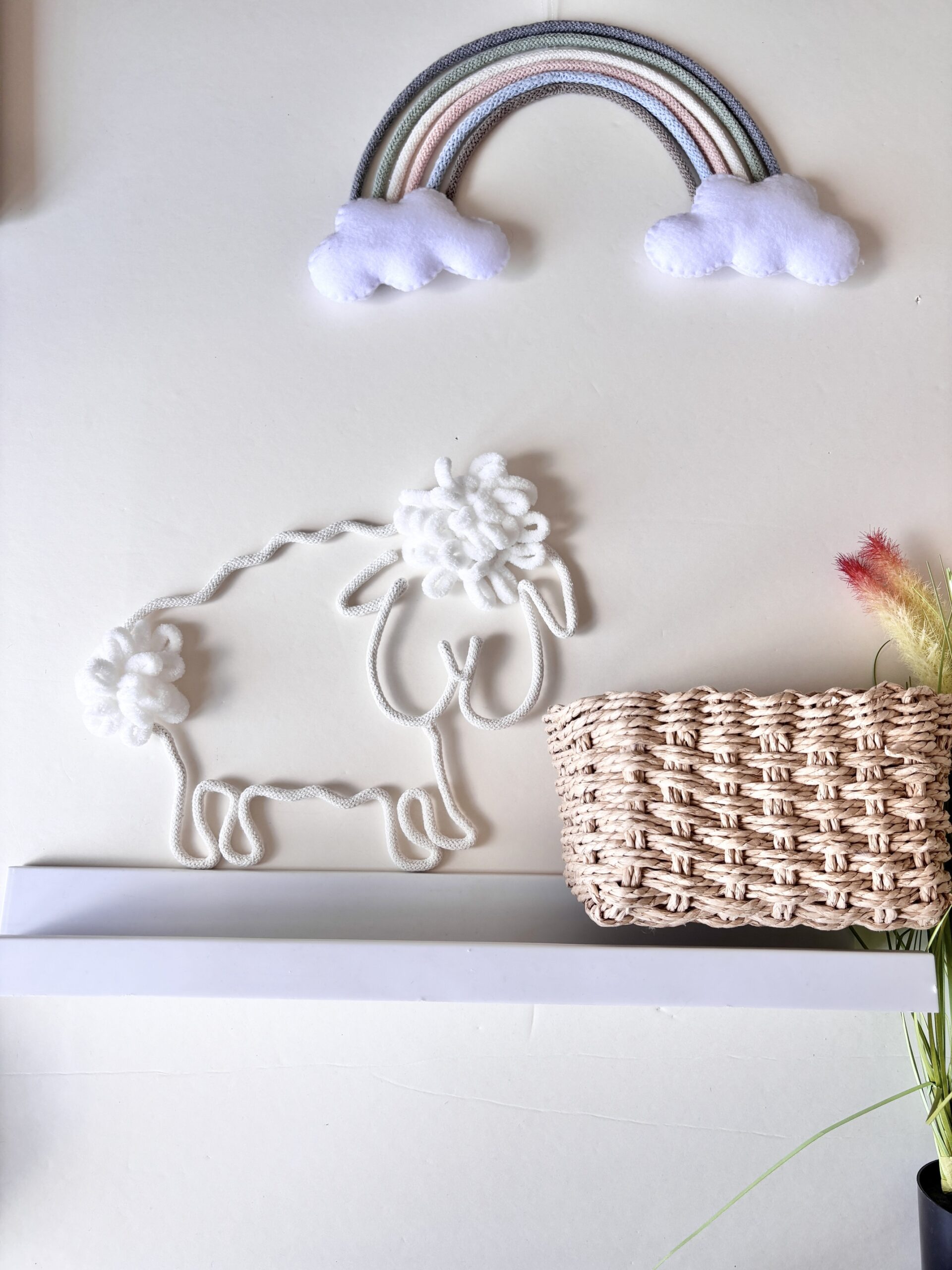 Handmade sheep nursery decor for a neutral baby room with soft cotton rope details.
