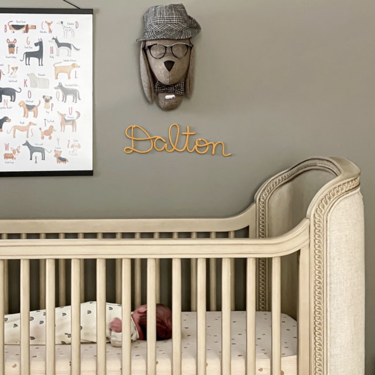 name sign hung above the cot for baby boy nursery