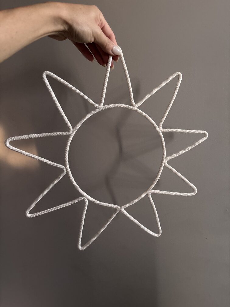 Minimalist cream sun nursery wall hanging with soft cotton cord, perfect for boho, Scandinavian and neutral baby room decor.