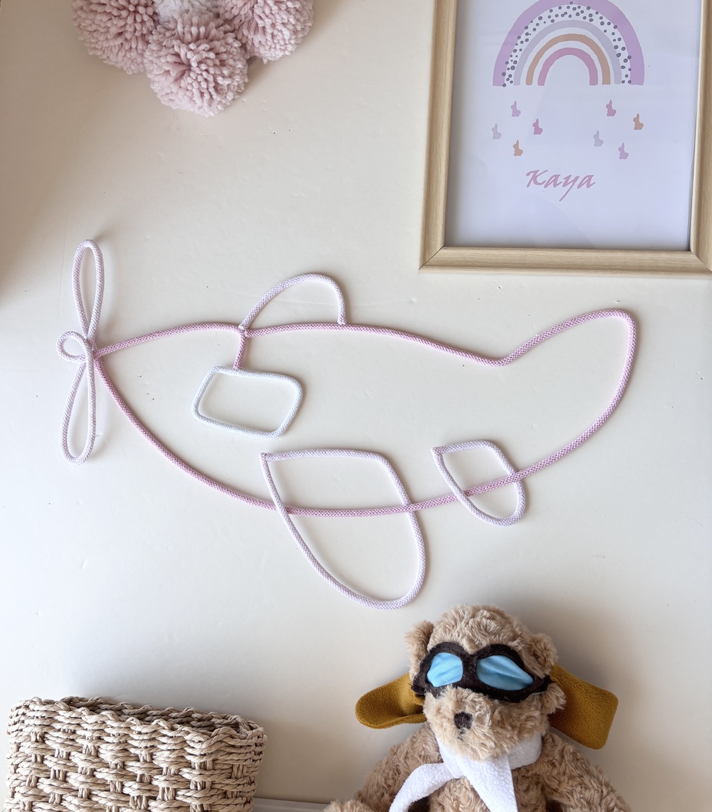 baby girl nursery gift featuring a handmade pink airplane wall decoration.