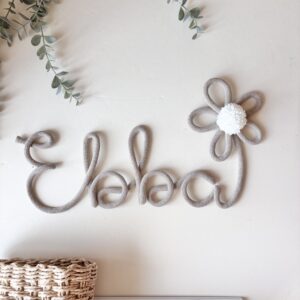 Handmade personalized daisy name sign with flower and pom pom for nursery wall decor