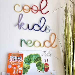 Cool Kids Read rainbow sign displayed in a colourful children's reading corner