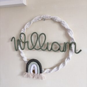 Personalised baby name hoop with rainbow detail and custom lettering for nursery wall decor.
