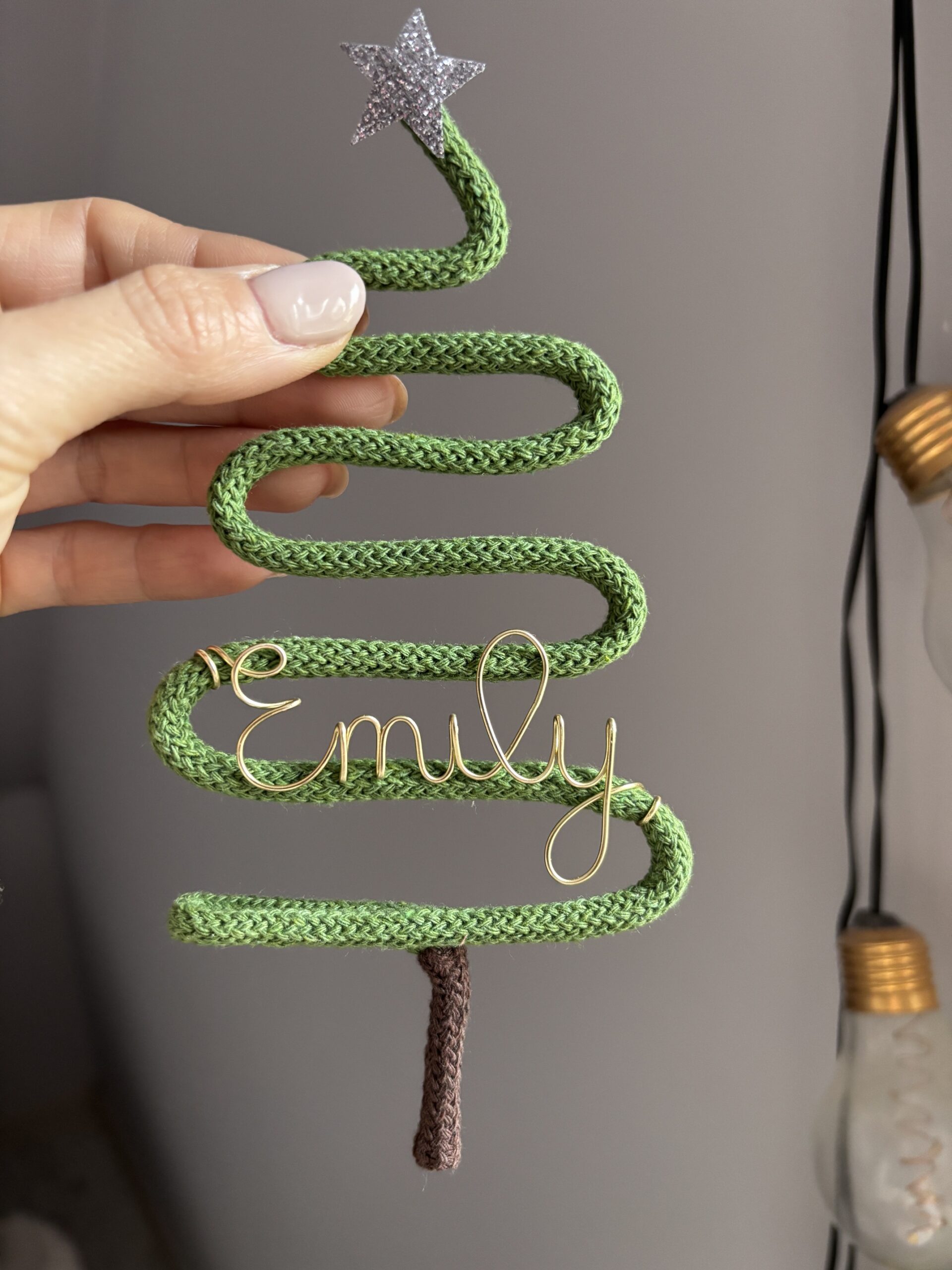Personalised miniature Christmas tree ornament featuring a custom name, measuring approximately 7 inches high and 3.5 inches wide